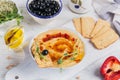 A bowl of chickpeas homemade hummus with olive oil, crispbread, microgreen and smoked paprika on wooden background