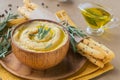 Bowl of chickpeas homemade hummus with olive oil, rosemary and crispbread