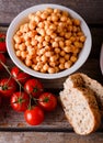 Bowl with chickpeas with tomatoes and bread