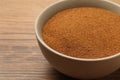 Bowl of chicory powder on wooden table, closeup