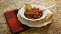 Bowl of chili with beans in a white bowl with bread on the side. Royalty Free Stock Photo