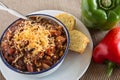 Bowl of Chili With Corn Bread Muffin Red Green Pepper