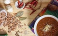 Bowl of Chili With Pinto Beans on Table With Peppers and Dry Beans in Background Royalty Free Stock Photo