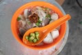 A bowl of Chinese noodle broth that is popular in Penang, Malaysia. The dish consists of flat rice noodles served with a clear