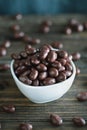 Bowl of Chocolate Covered Raisins over a Rustic Background Royalty Free Stock Photo