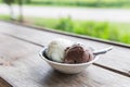 Bowl of various colorful ice cream balls on wooden background