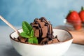 Bowl of chocolate ice cream with mint on table, closeup Royalty Free Stock Photo