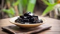 A bowl of chocolate squares on a wooden tray