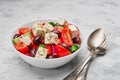 A bowl of classic Greek salad with cutlery on a table Royalty Free Stock Photo