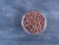 Bowl of cocoa nibs on a blue and white background