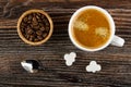 Bowl with coffee beans, cup with coffee, spoon, pieces of sugar on wooden table. Top view Royalty Free Stock Photo