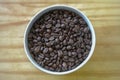 Bowl of coffee beans on the wood table