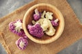 Bowl with colorful cauliflowers on table Royalty Free Stock Photo