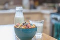 Bowl of colorful children`s cereal and milk isolated on wood table with Text space