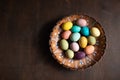 Bowl with colorful easter eggs on wooden table. Space for text. Happy Easter Royalty Free Stock Photo