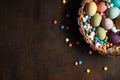 Bowl with colorful easter eggs on wooden table. Space for text. Happy Easter Royalty Free Stock Photo