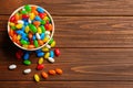 Bowl with colorful jelly beans on wooden background. Space for text Royalty Free Stock Photo