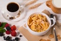 Bowl of commercial breakfast cereal with coffee