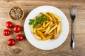 Bowl with condiment, tomatoes, plate with slices of fried potato, fork on table. Top view Royalty Free Stock Photo