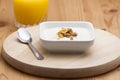 Bowl of conflakes yogurt and orange juice