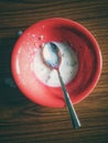A bowl containing milk leftover after a child has finished eating breakfast