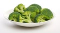 A bowl of cooked green broccoli with sea salt, shot from above on a white plate. Generative AI