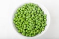 A bowl of cooked green peas, top view