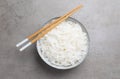 Bowl with cooked rice noodles and chopsticks on light grey table, top view Royalty Free Stock Photo