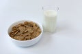 Bowl of corn flakes and glass of milk on white background, healthy breakfast Royalty Free Stock Photo