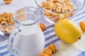 Bowl with corn flakes, jug of milk