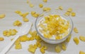 Bowl of corn flakes and spoon on wood background