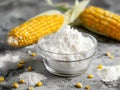 bowl with corn starch on kitchen table and ear of corn Royalty Free Stock Photo