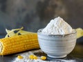 bowl with corn starch on kitchen table and ear of corn