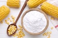 Bowl with corn starch, ripe cobs and kernels on white wooden table, flat lay Royalty Free Stock Photo