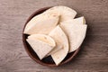 Bowl with corn tortillas on wooden background. Unleavened bread