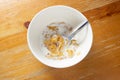 Bowl of cornflakes in milk on wood background from above Royalty Free Stock Photo