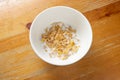 Bowl of cornflakes in milk on wood background from above Royalty Free Stock Photo