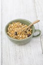 A bowl of cornflakes on a wood table