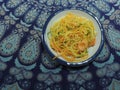 Bowl of courgette noodles zucchini courgetti butternut squash white bowl mandala tablecloth Royalty Free Stock Photo