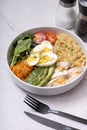 A bowl of couscous, meat, eggs and vegetables angle view on grey background. Royalty Free Stock Photo