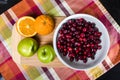 Bowl of cranberries with apples and oranges Royalty Free Stock Photo