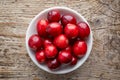 Bowl of cranberries on wooden table, from above