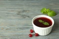 Bowl of cranberry sauce on gray wooden background Royalty Free Stock Photo