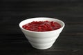 Bowl of cranberry sauce on wooden background Royalty Free Stock Photo