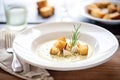 a bowl of creamy artichoke heart soup with croutons Royalty Free Stock Photo