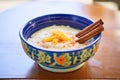 a bowl of creamy rice pudding with a cinnamon stick garnish Royalty Free Stock Photo