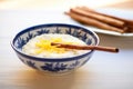 a bowl of creamy rice pudding with a cinnamon stick garnish Royalty Free Stock Photo