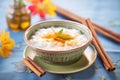 a bowl of creamy rice pudding with a cinnamon stick garnish Royalty Free Stock Photo