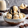 Bowl of creamy and rich vanilla ice cream with chocolate sauce