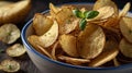 Crispy Homemade Potato Chips in a Bowl with Basil Garnishing on a Rustic Wooden Table Royalty Free Stock Photo